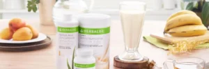 Productos Herbalife para un Peso Saludable acompañados de frutas frescas en una mesa, destacando la naturalidad y los beneficios nutricionales.